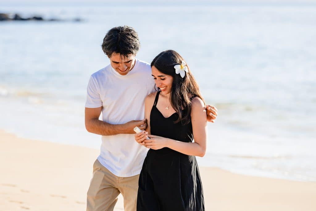 Hector holding Alejandra as she smiles and laughs while looking down at the letter in her hand.