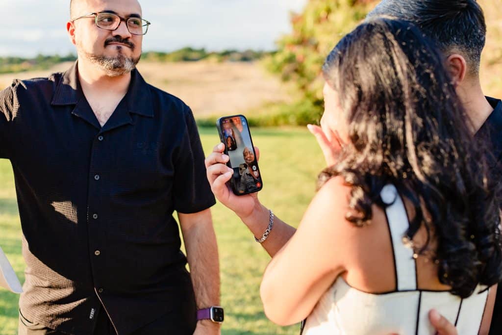 Tithi talking to family on Facetime as she shows off her new engagement ring. 