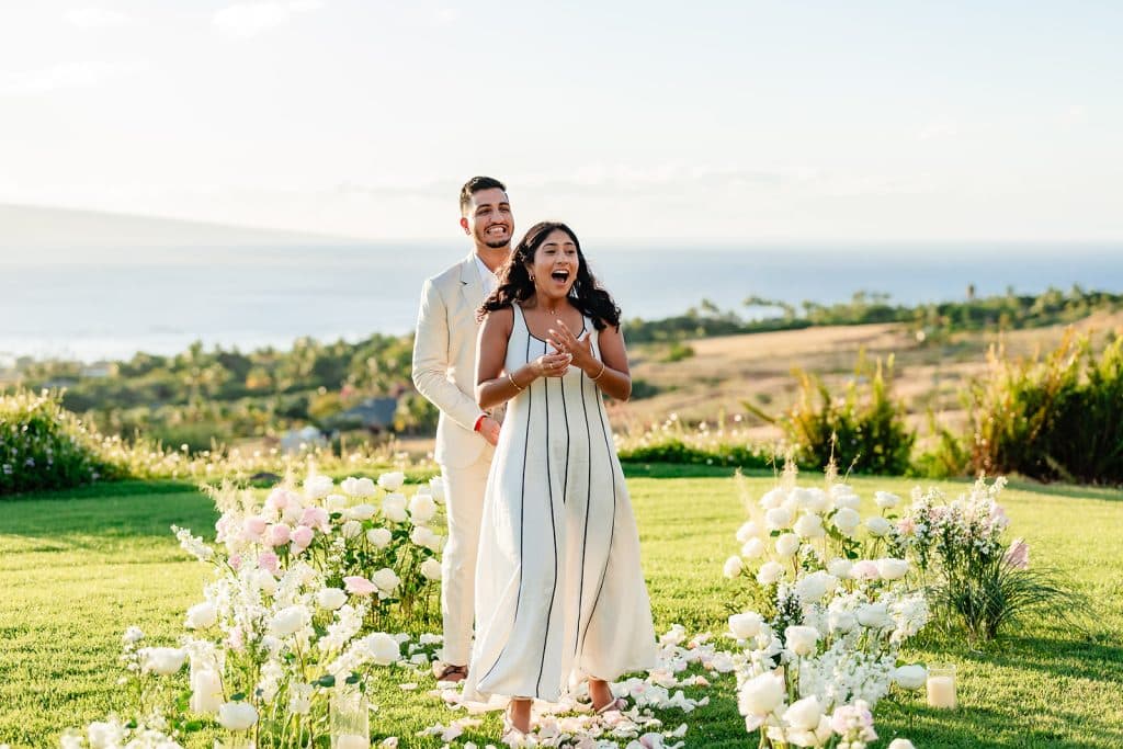 Tithi walking down the floral path in shock as she sees her family entering the lookout. Pruthvi is behind her smiling.